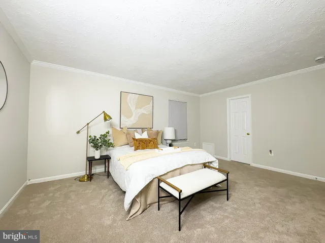 a bedroom with a bed and a table