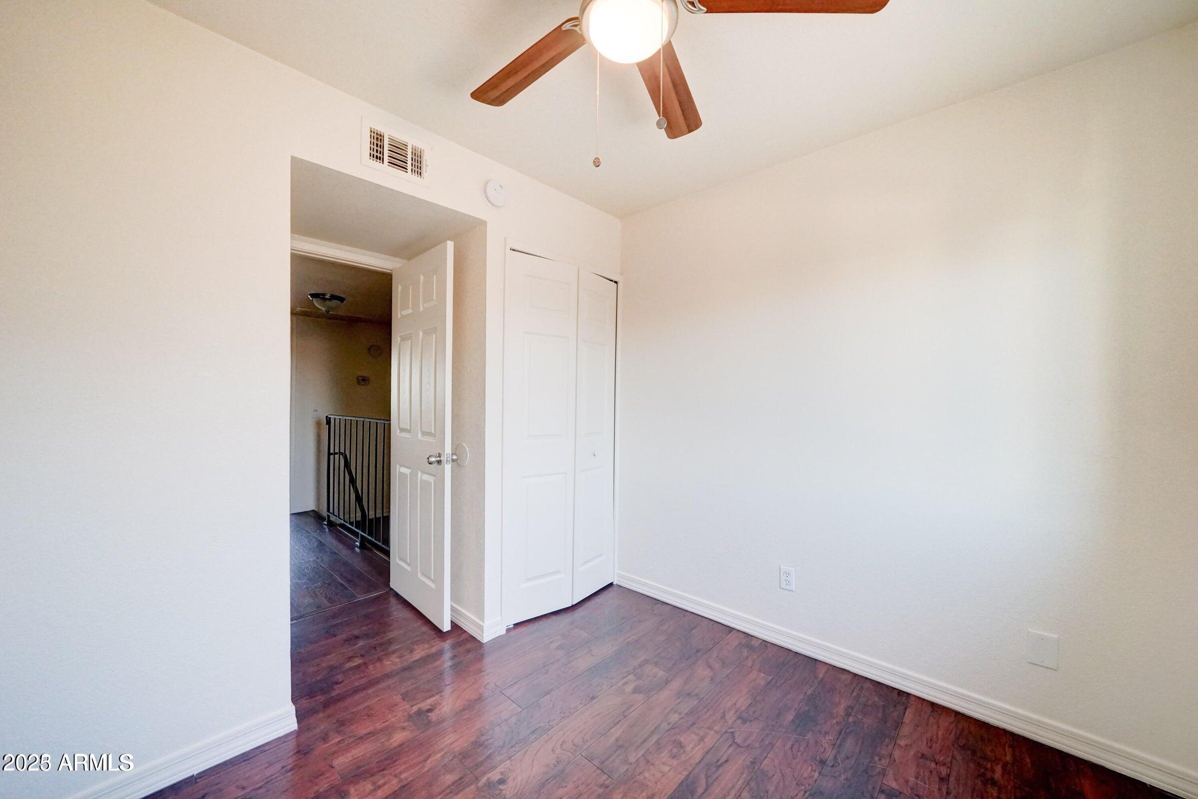 3605 West Bethany Home Road, Unit 17 Phoenix, AZ 85019 - Photo 11 of 13 a view of an empty room with wooden floor