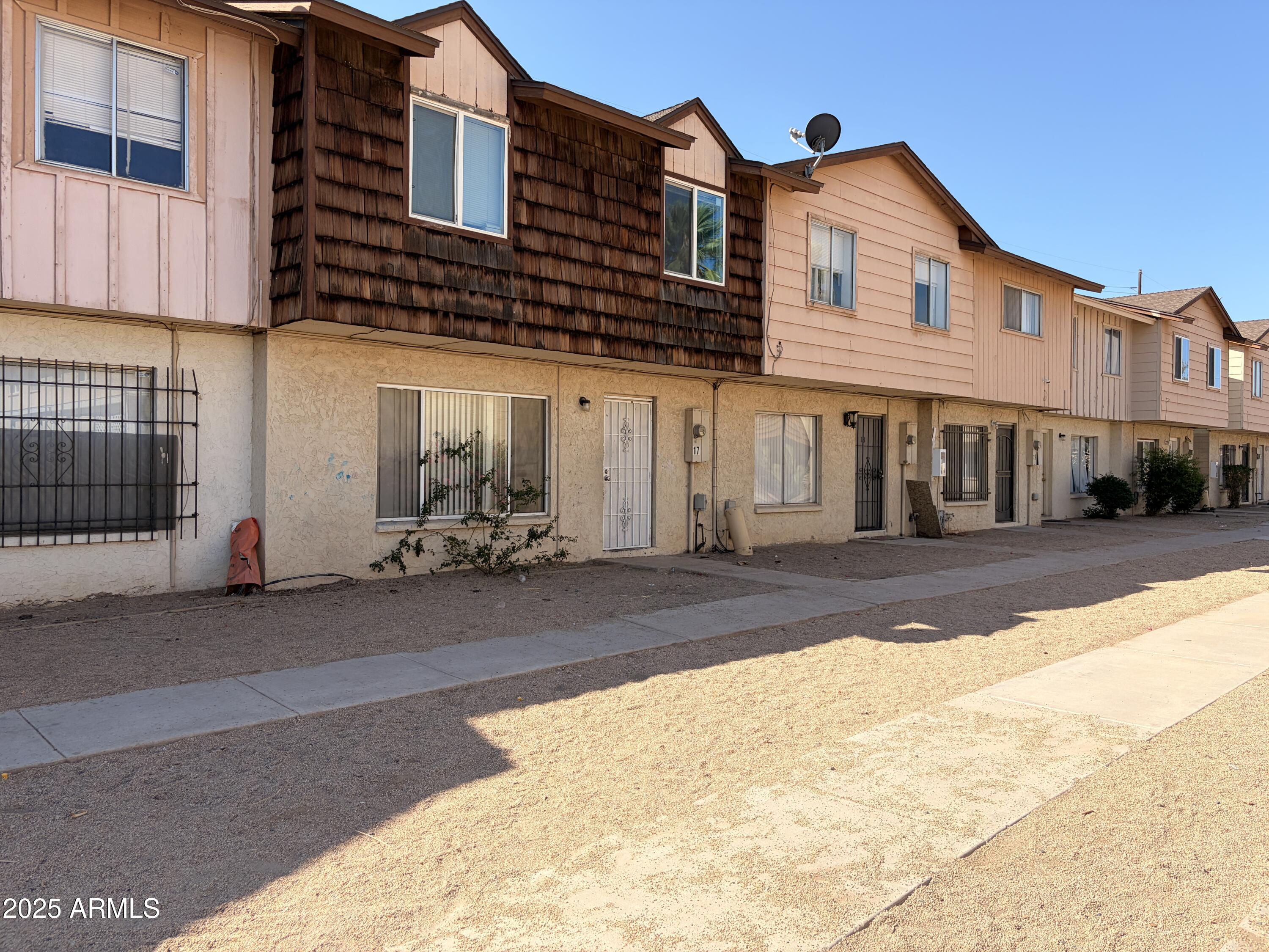 3605 West Bethany Home Road, Unit 17 Phoenix, AZ 85019 - Photo 3 of 13 a front view of a house with a road