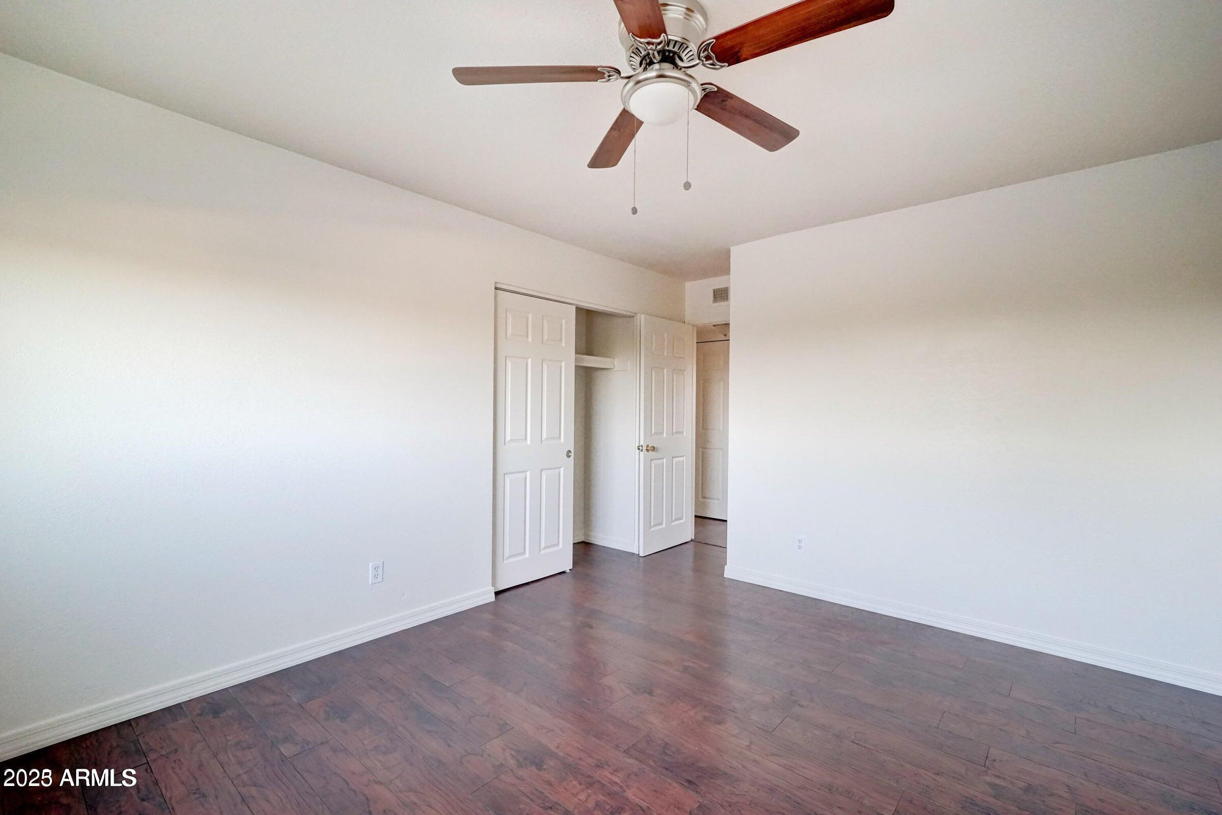3605 West Bethany Home Road, Unit 17 Phoenix, AZ 85019 - Photo 10 of 13 wooden floor in an empty room