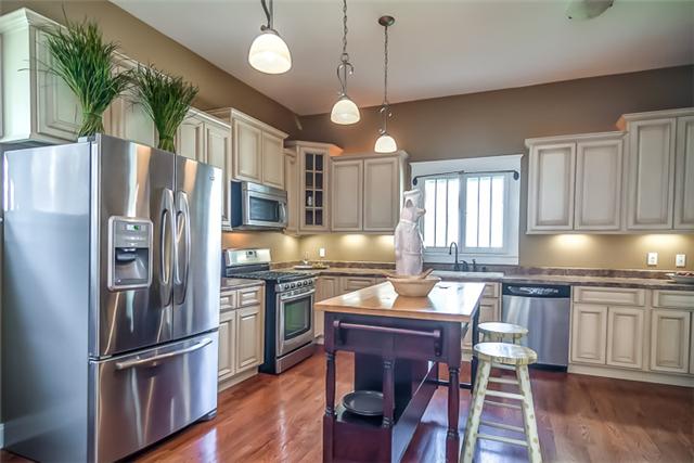 327 North Walnut Street Springfield, TN 37172 - Photo 7 of 20 You will enjoy cooking in this custom kitchen. Features include stainless steel appliance, custom cabinets and sink under cabinet lights and large island that can be used for extra seating.