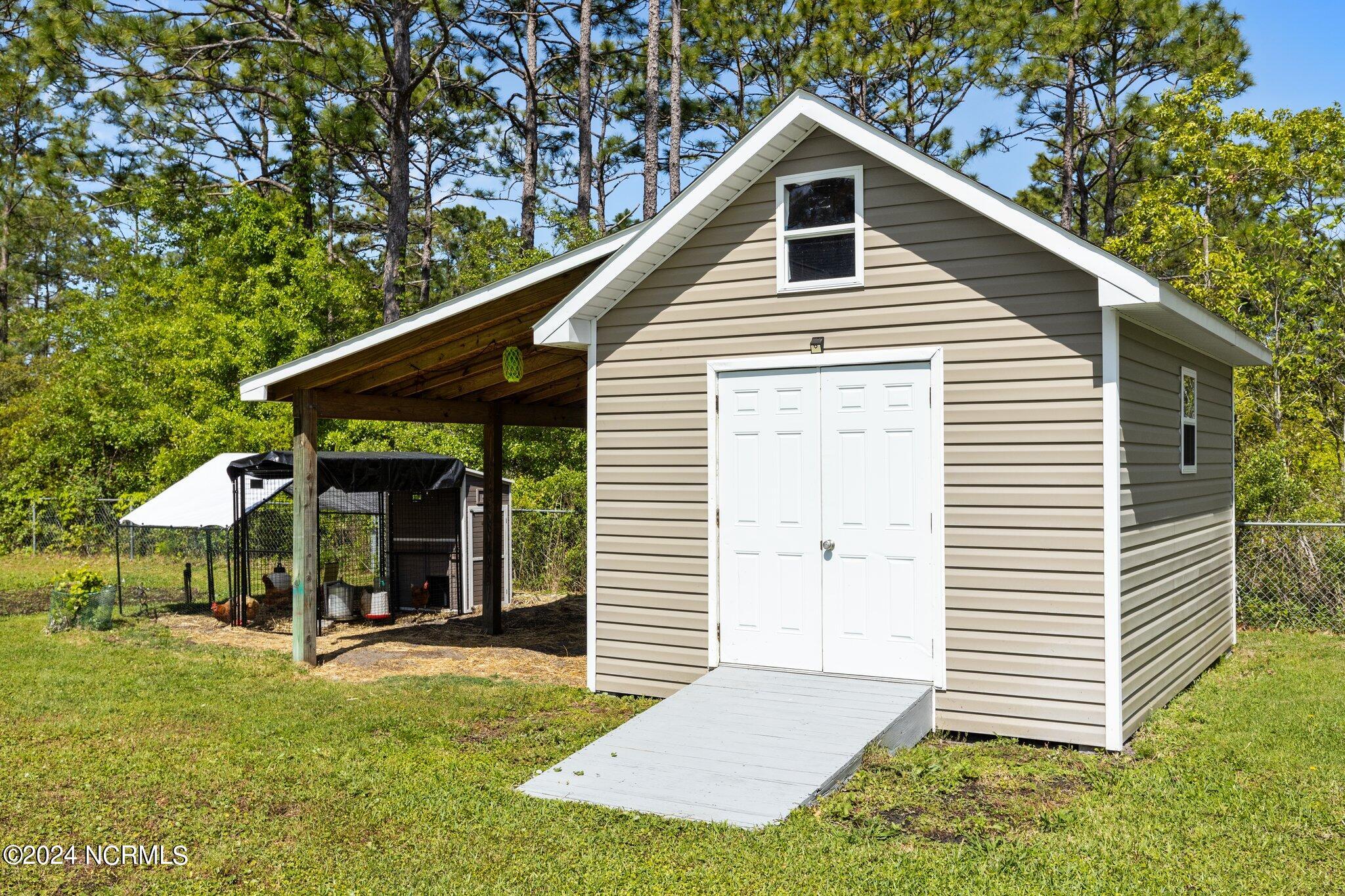 366 Barrington Ridge Bogue, NC 28570 - Photo 7 of 44 Shed with ramp -lean to and chicken area (note that chickens are not permitted per the restrictive covenants)