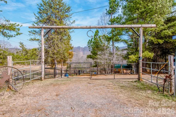 a view of outdoor space with wooden fence and trees