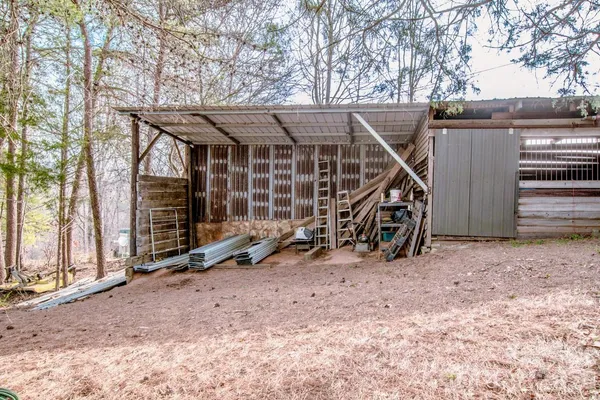 a backyard of a house with table and chairs
