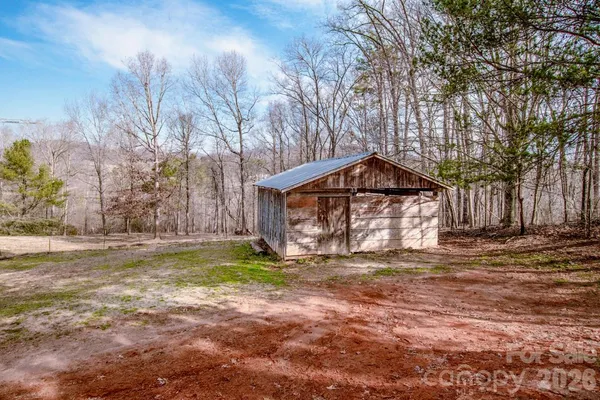 a view of a backyard with wooden floor and fence