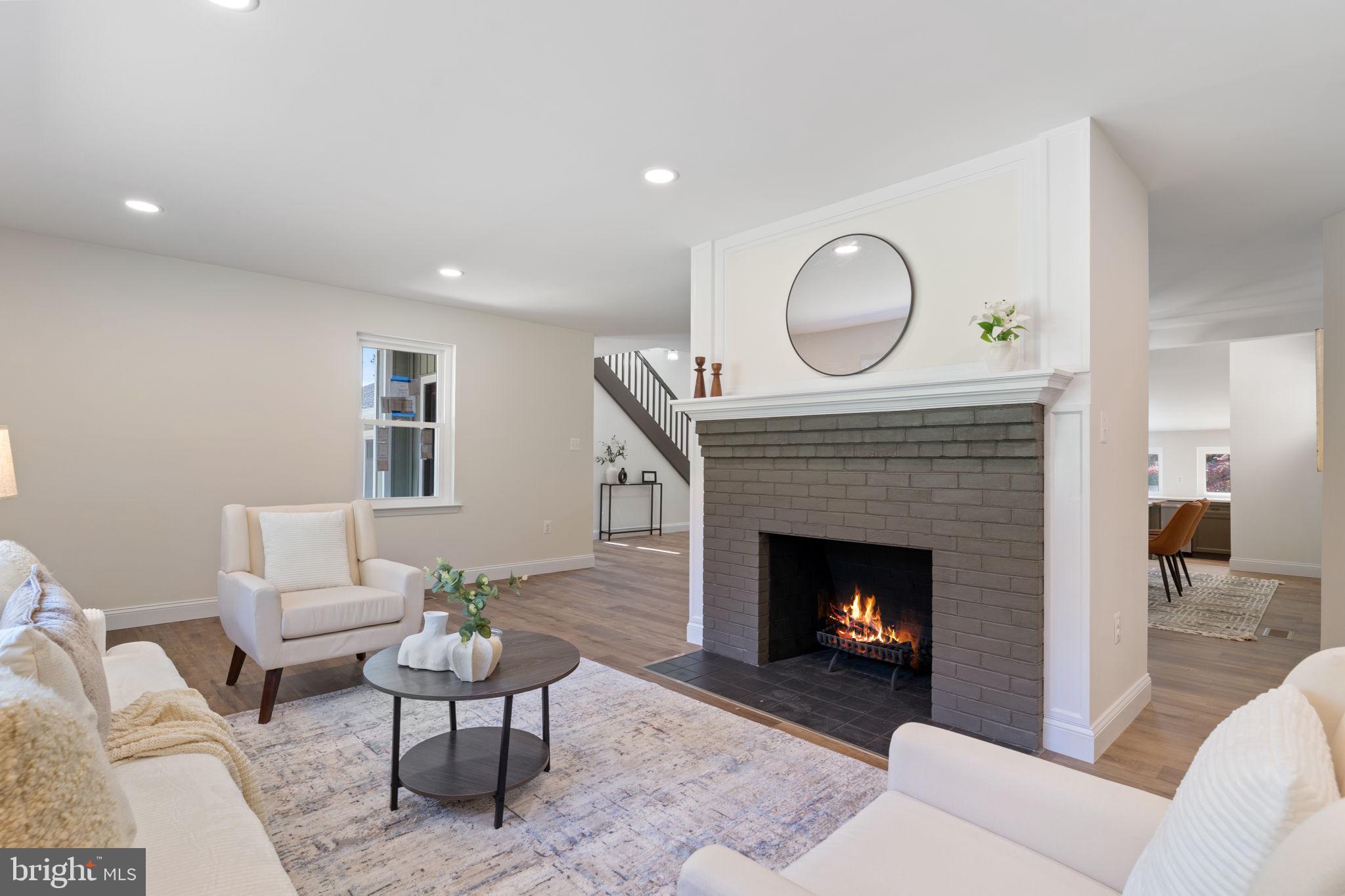 4735 Paul Hance Road Huntingtown, MD 20639 - Photo 10 of 64 a living room with furniture a fireplace and a fireplace