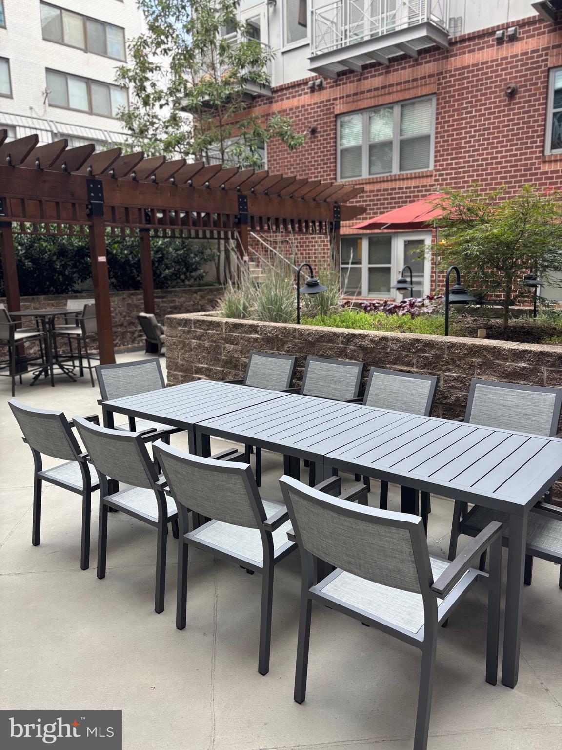 1300 N Street Northwest, Unit 21 Washington, DC 20005 - Photo 17 of 21 a view of a patio with a table and chairs