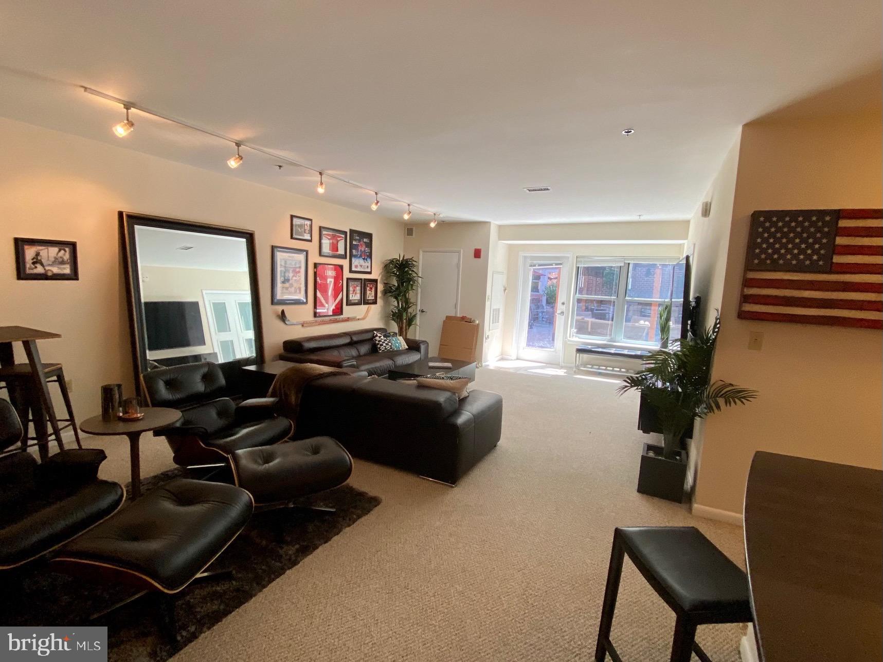1300 N Street Northwest, Unit 21 Washington, DC 20005 - Photo 18 of 21 a living room with furniture and a flat screen tv