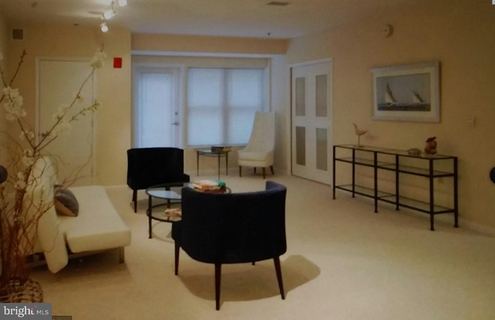 1300 N Street Northwest, Unit 21 Washington, DC 20005 - Photo 8 of 21 a living room with furniture and a lamp