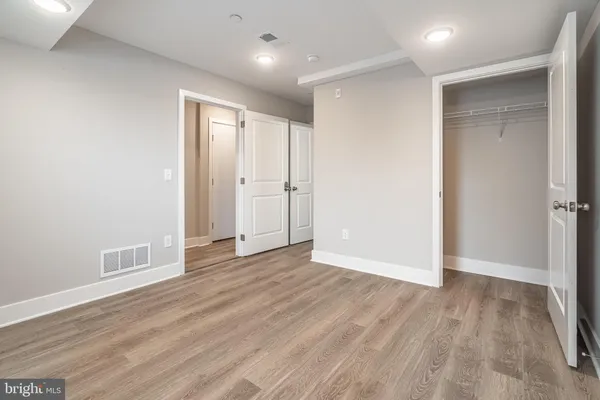 a view of an empty room with wooden floor
