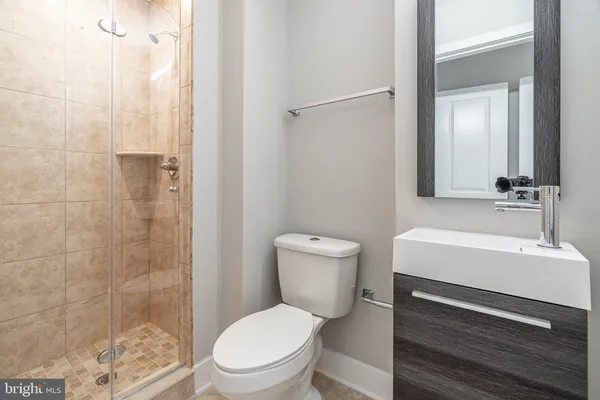 a white toilet sitting next to a bathroom sink