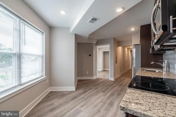 a view of a refrigerator in kitchen and wooden floor