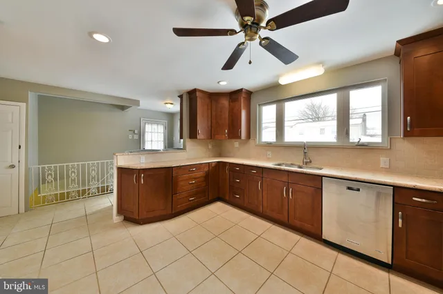 a kitchen with a sink a stove cabinets and window