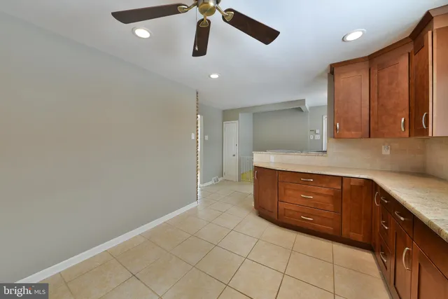 a spacious bathroom with a granite countertop sink a mirror and a vanity