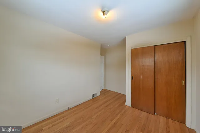 a view of a room with wooden floor and brick wall