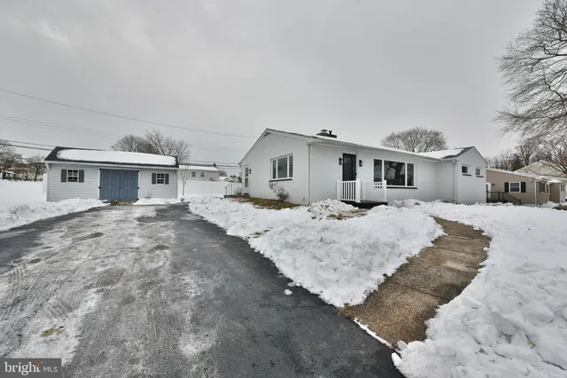 a view of a house with a snow in the background