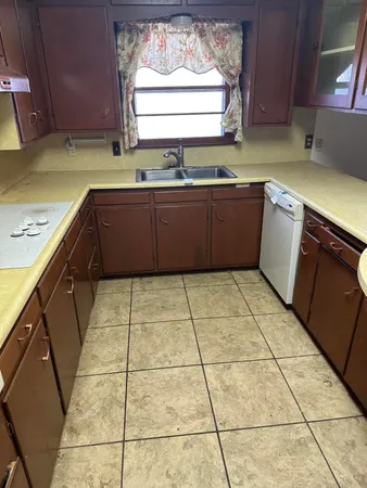 a kitchen with a sink a stove a microwave and cabinets