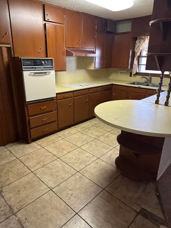 a kitchen with stainless steel appliances a sink and a stove