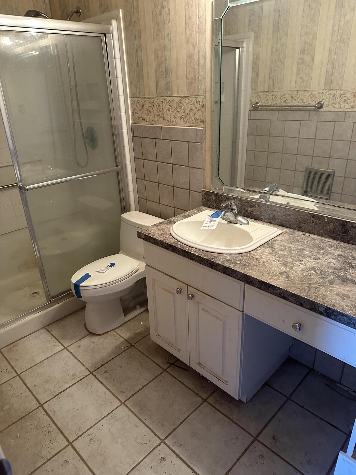600 Southwest Ave J Seminole, TX 79360 - Photo 21 of 27 a bathroom with a granite countertop sink and a mirror