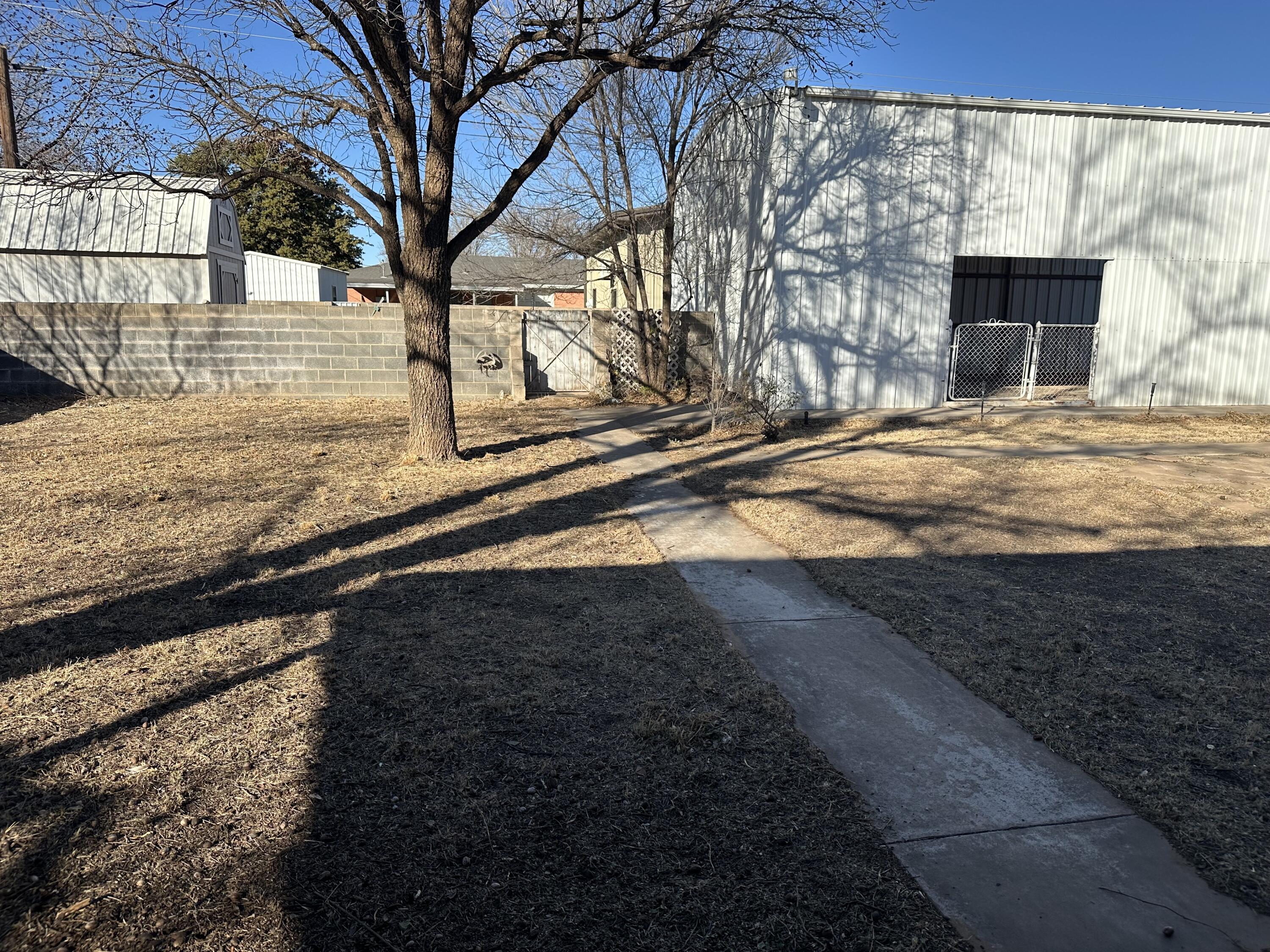 600 Southwest Ave J Seminole, TX 79360 - Photo 23 of 27 a view of a yard with wooden fence