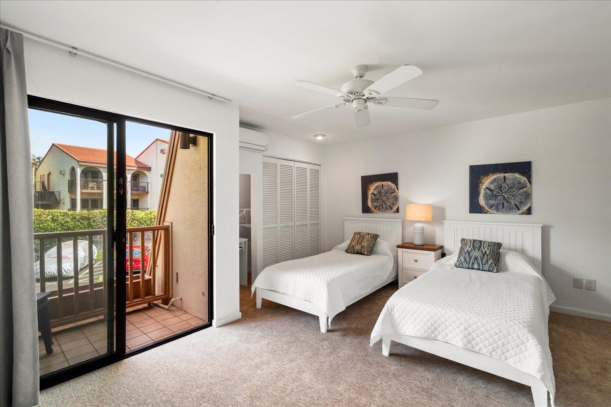 2777 South Kihei Road, Unit F203 Kihei, HI 96753 - Photo 13 of 37 a spacious bedroom with two beds and a chandelier