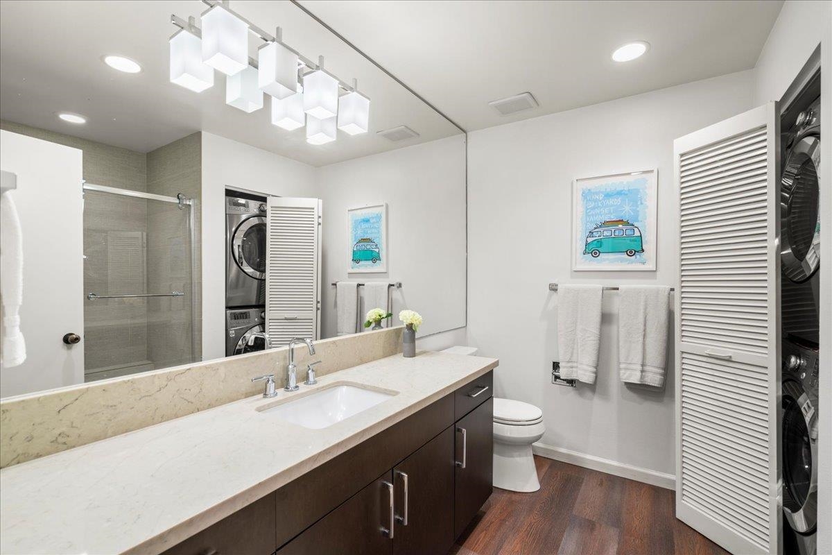 2777 South Kihei Road, Unit F203 Kihei, HI 96753 - Photo 16 of 37 a bathroom with a granite countertop sink a toilet a mirror and shower