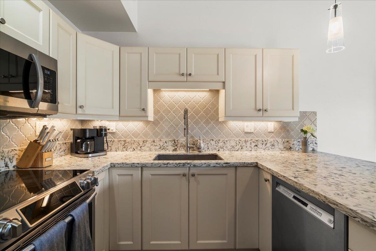 2777 South Kihei Road, Unit F203 Kihei, HI 96753 - Photo 23 of 37 a kitchen with stainless steel appliances granite countertop a sink stove and cabinets