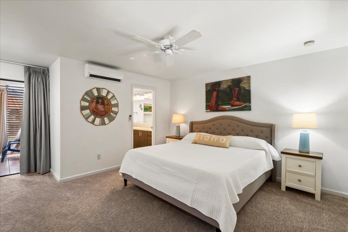 2777 South Kihei Road, Unit F203 Kihei, HI 96753 - Photo 31 of 37 a bedroom with a bed and a chandelier