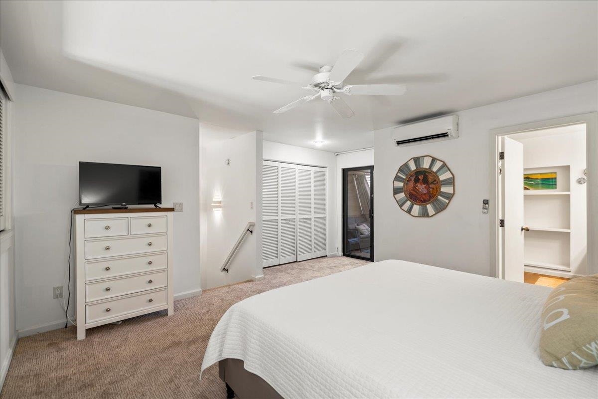 2777 South Kihei Road, Unit F203 Kihei, HI 96753 - Photo 32 of 37 a bedroom with a large bed and a flat tv screen on dresser