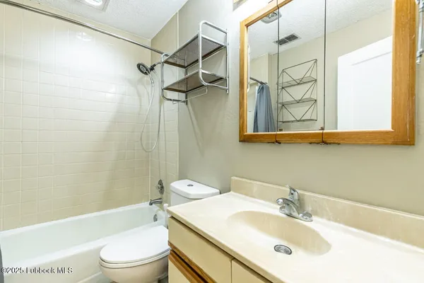 a bathroom with a sink toilet tub and shower