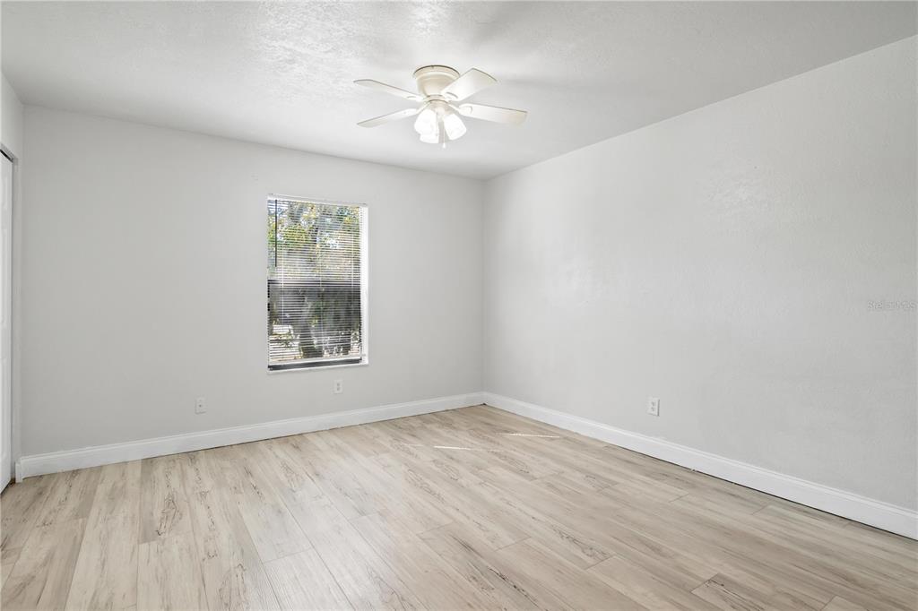 980 Canal View Boulevard, Unit I3 Port Orange, FL 32129 - Photo 11 of 17 wooden floor in an empty room with a window