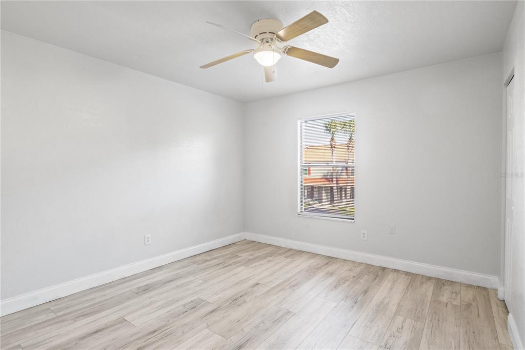 980 Canal View Boulevard, Unit I3 Port Orange, FL 32129 - Photo 12 of 17 wooden floor in an empty room with a window