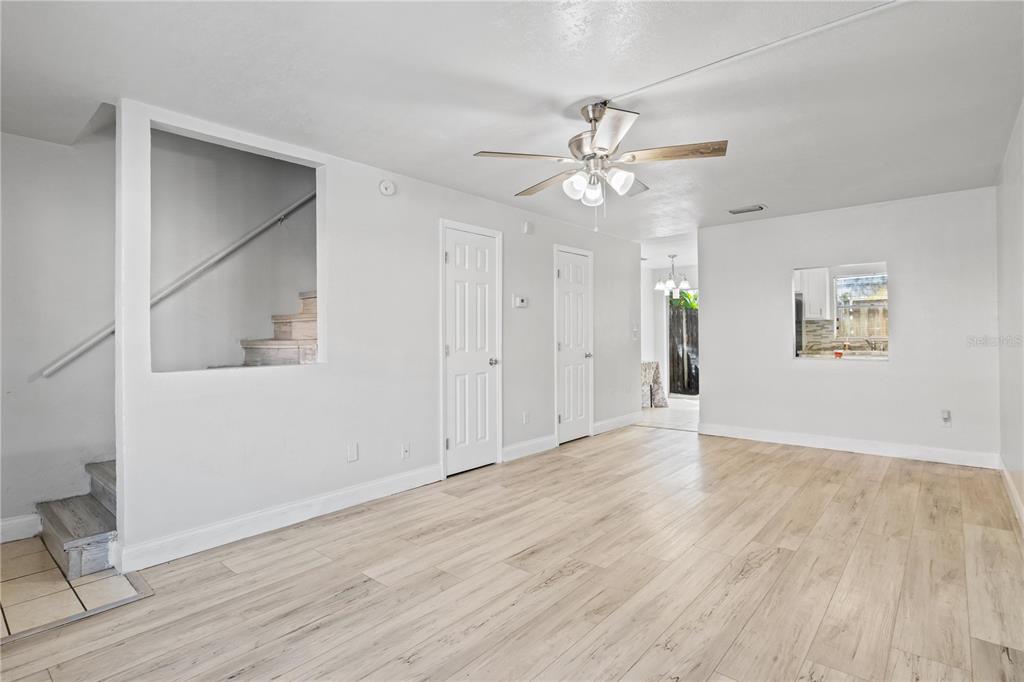 980 Canal View Boulevard, Unit I3 Port Orange, FL 32129 - Photo 3 of 17 a view of an empty room with wooden floor and a ceiling fan