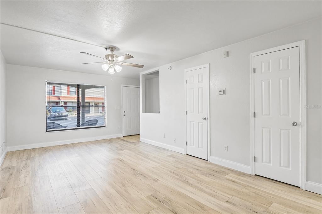 980 Canal View Boulevard, Unit I3 Port Orange, FL 32129 - Photo 4 of 17 a view of an empty room with a window and wooden floor