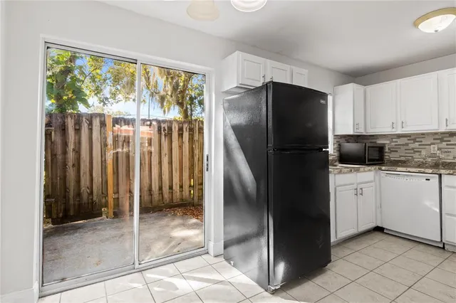 a kitchen with a refrigerator a stove a sink and cabinets