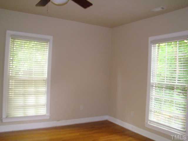 623 Tower Street Raleigh, NC 27607 - Photo 3 of 6 a view of an empty room with wooden floor and a window