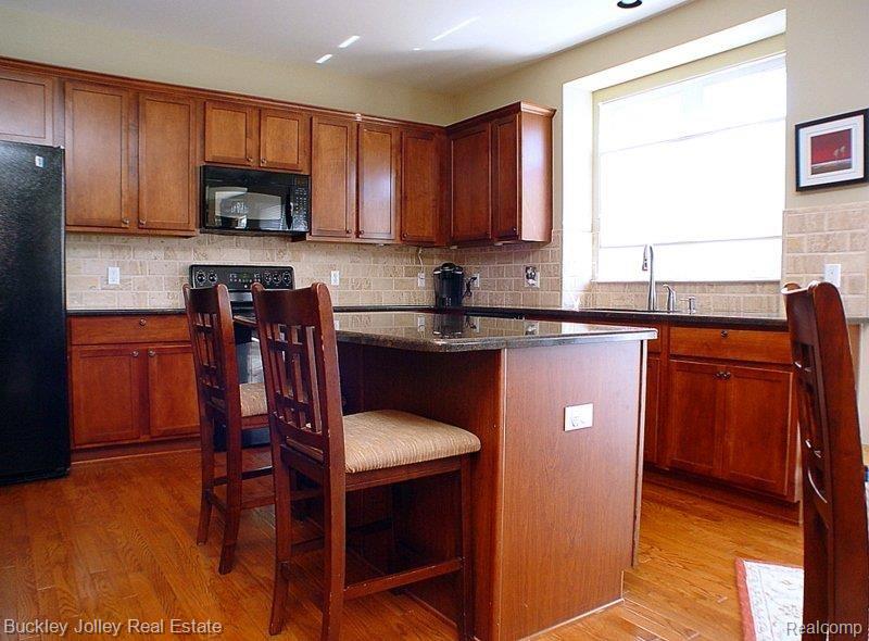 4269 Merriman Loop Howell, MI 48843 - Photo 6 of 23 Cherry Cabinets in the Kitchen