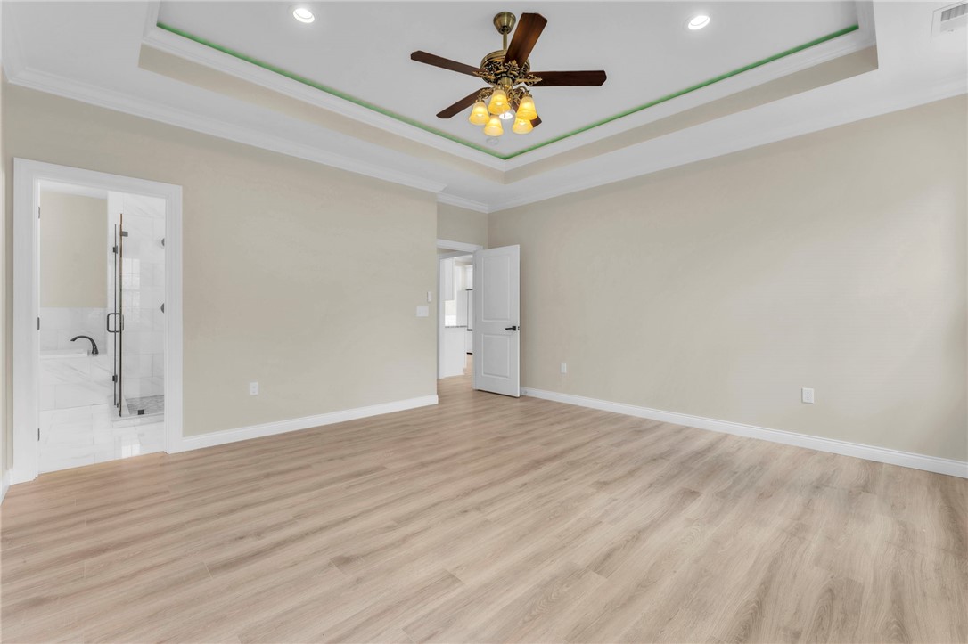1015 Winmar Drive Anderson, SC 29621 - Photo 22 of 49 This spacious primary bedroom features tray ceilings and light wood flooring, offering a serene retreat.