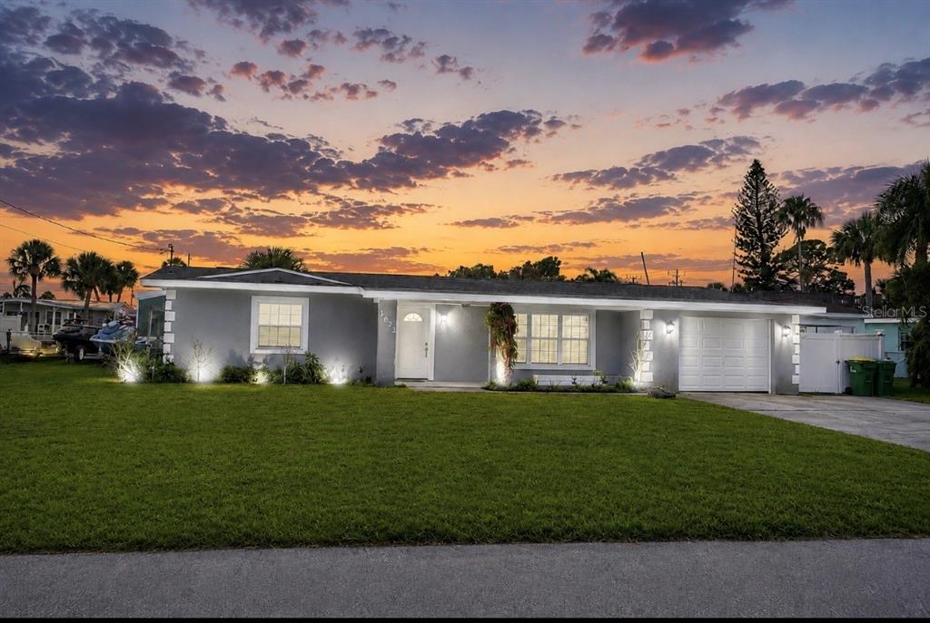1623 Wavecrest Street Merritt Island, FL 32952 - Photo 2 of 26 a front view of a house with a garden