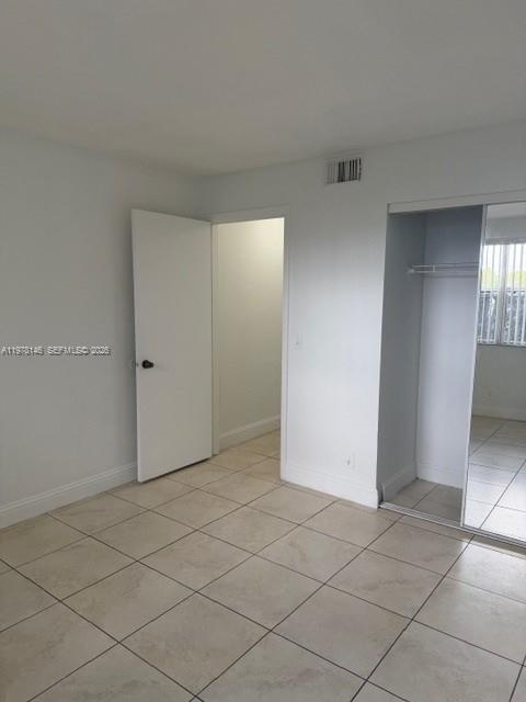 8781 Wiles Road, Unit 103 Coral Springs, FL 33067 - Photo 12 of 19 an empty room with a fireplace
