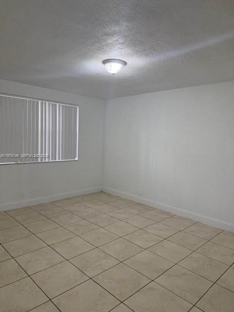 8781 Wiles Road, Unit 103 Coral Springs, FL 33067 - Photo 14 of 19 a view of an empty room and window