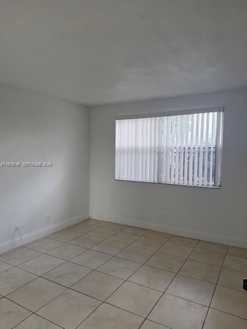 8781 Wiles Road, Unit 103 Coral Springs, FL 33067 - Photo 15 of 19 an empty room with windows
