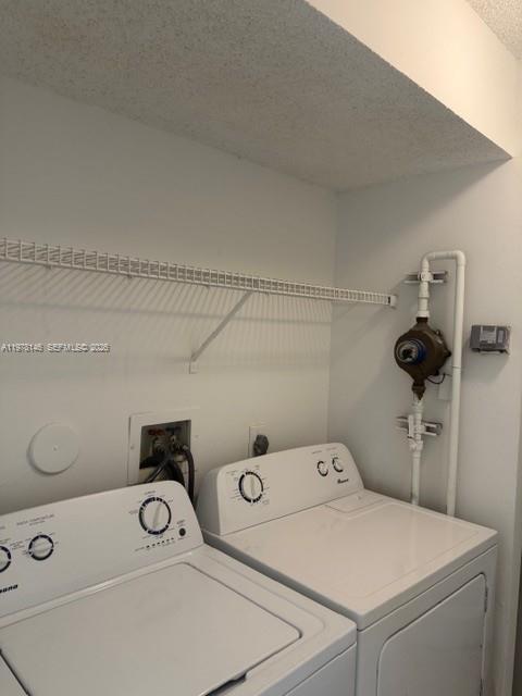 8781 Wiles Road, Unit 103 Coral Springs, FL 33067 - Photo 19 of 19 a utility room with dryer and washer