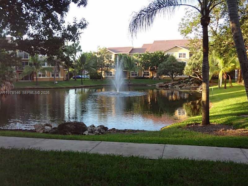 8781 Wiles Road, Unit 103 Coral Springs, FL 33067 - Photo 2 of 19 a view of a lake with a big yard