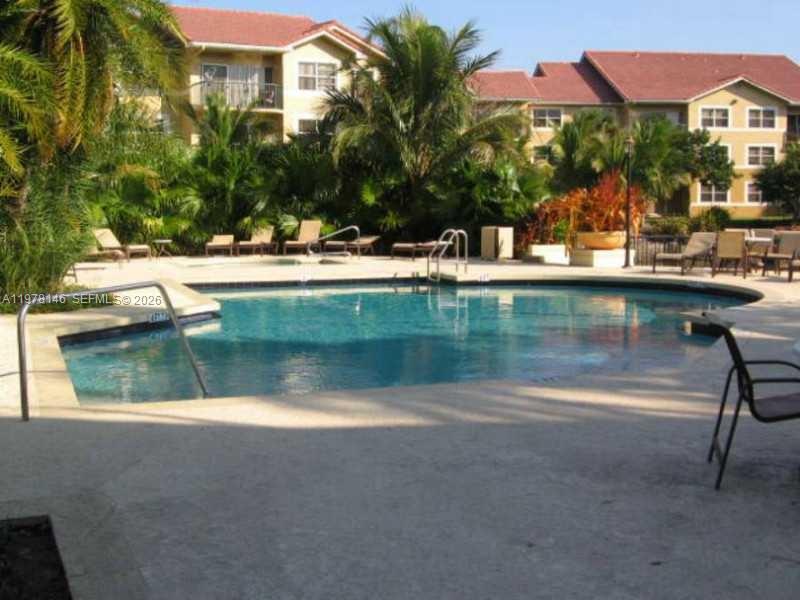 8781 Wiles Road, Unit 103 Coral Springs, FL 33067 - Photo 3 of 19 a view of swimming pool with a yard