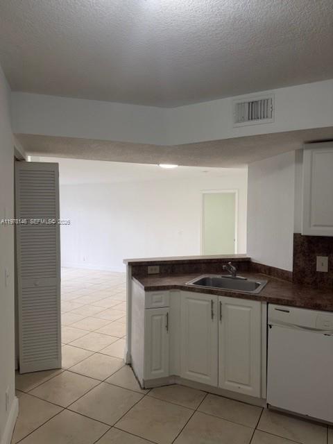 8781 Wiles Road, Unit 103 Coral Springs, FL 33067 - Photo 8 of 19 a kitchen with white cabinets
