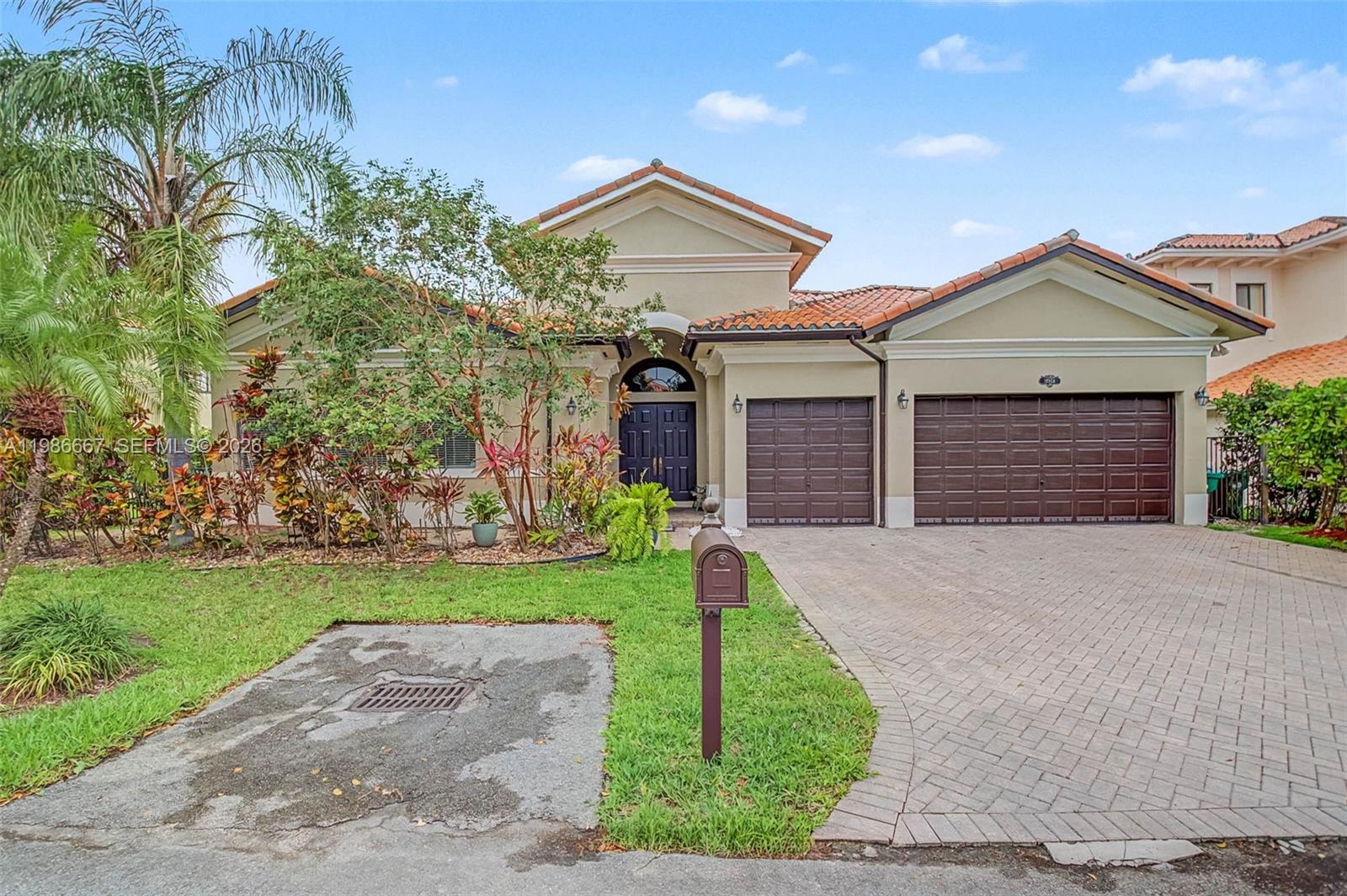19528 Southwest 79th Place Cutler Bay, FL 33157 - Photo 1 of 41 a front view of a house with a garden and yard