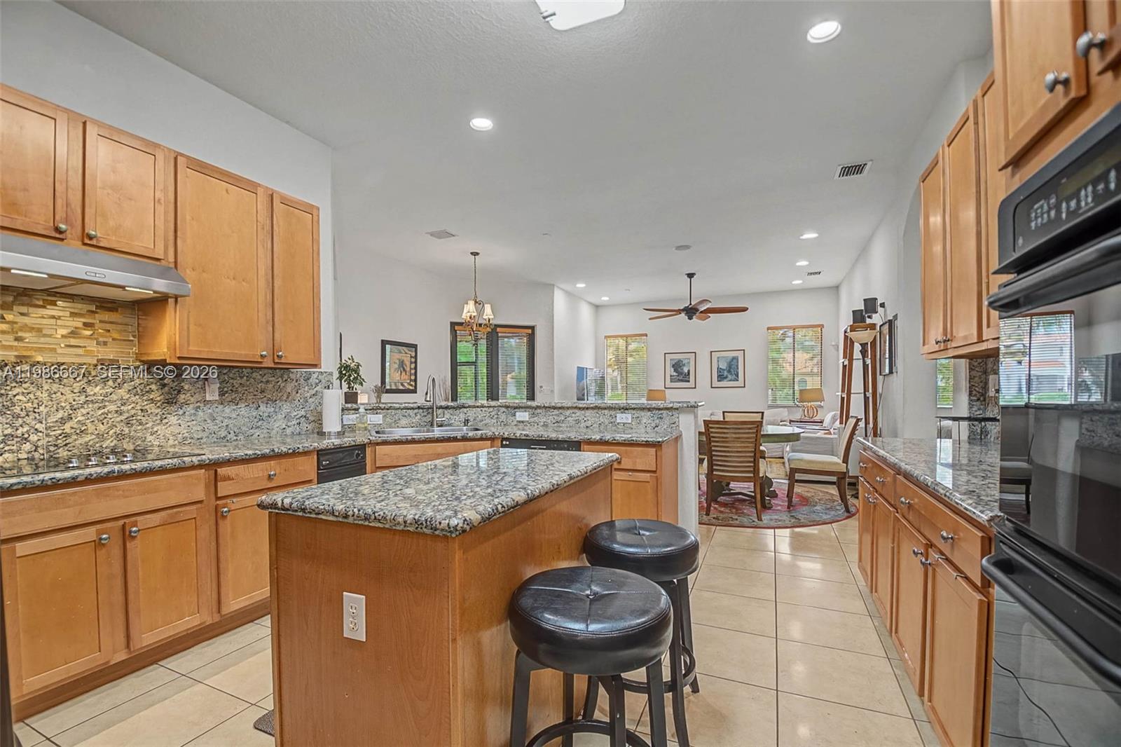 19528 Southwest 79th Place Cutler Bay, FL 33157 - Photo 12 of 41 a kitchen with stainless steel appliances granite countertop table chairs sink and cabinets