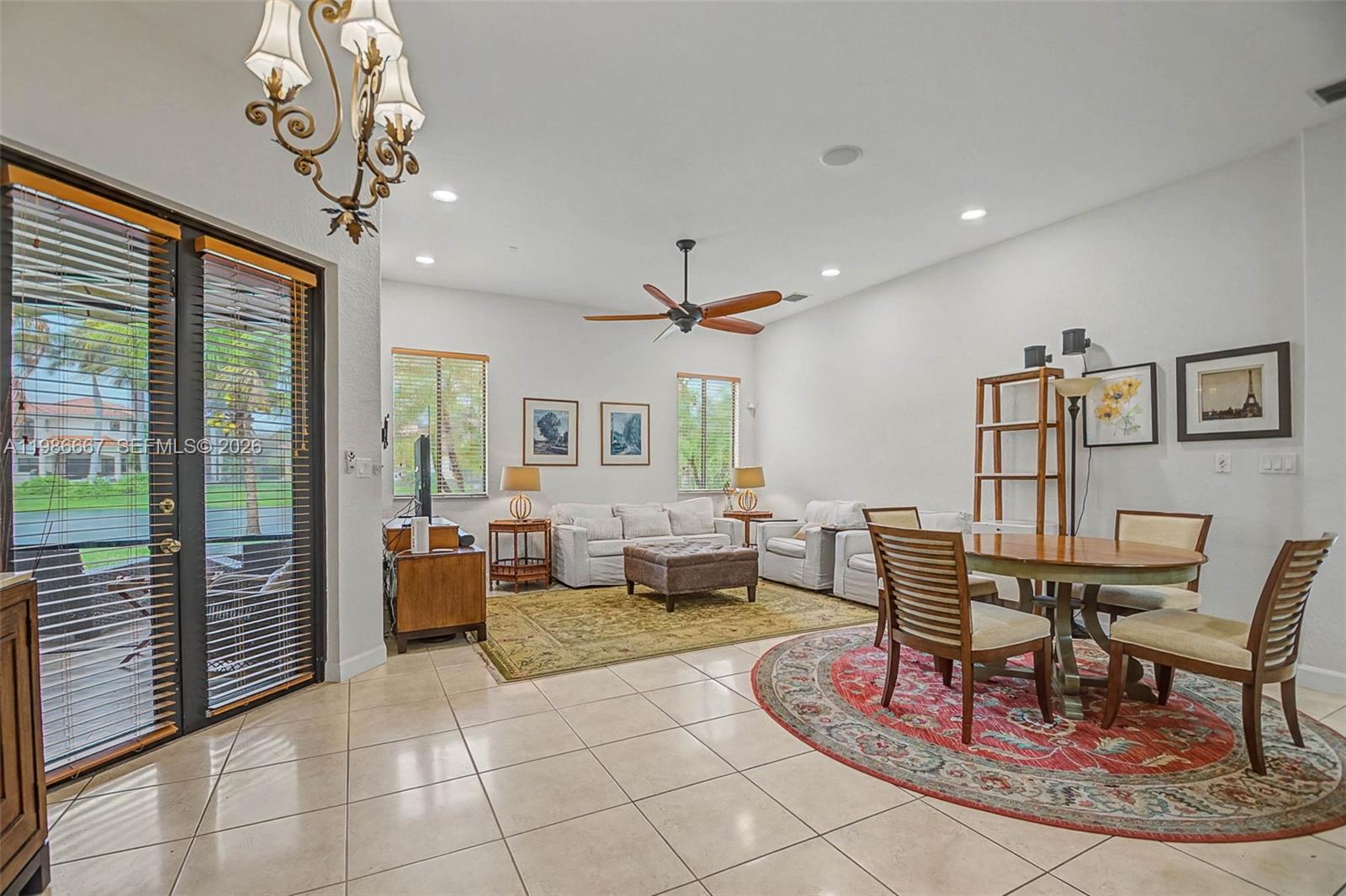 19528 Southwest 79th Place Cutler Bay, FL 33157 - Photo 14 of 41 a living room with furniture a dining table and a chandelier