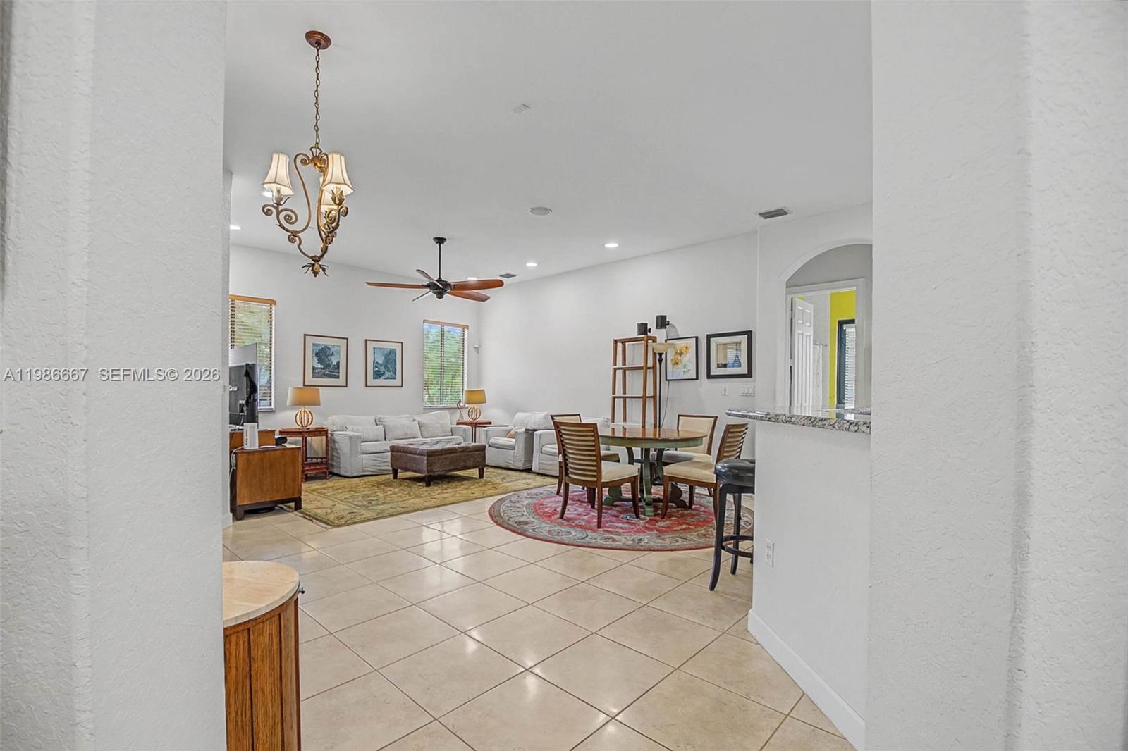 19528 Southwest 79th Place Cutler Bay, FL 33157 - Photo 15 of 41 a living room with fireplace furniture and a chandelier